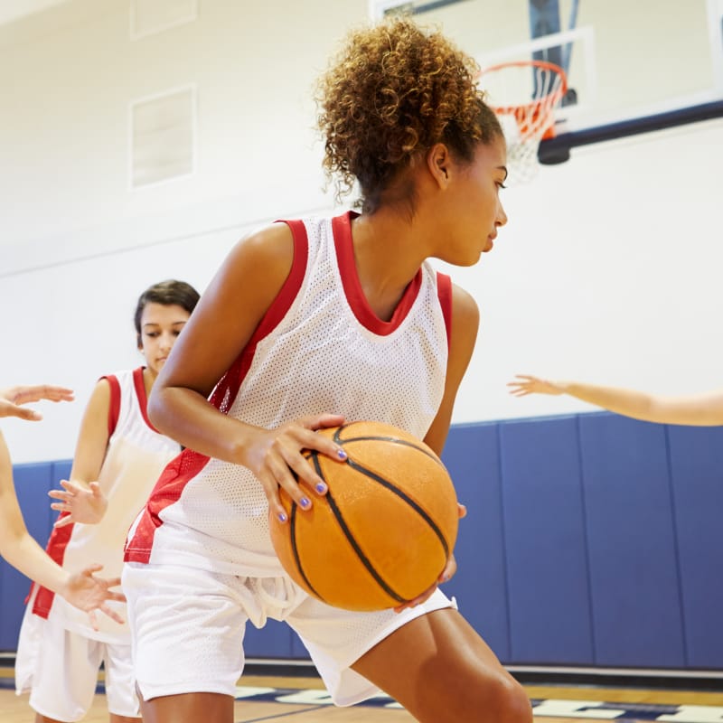 Teen girls playing basketball